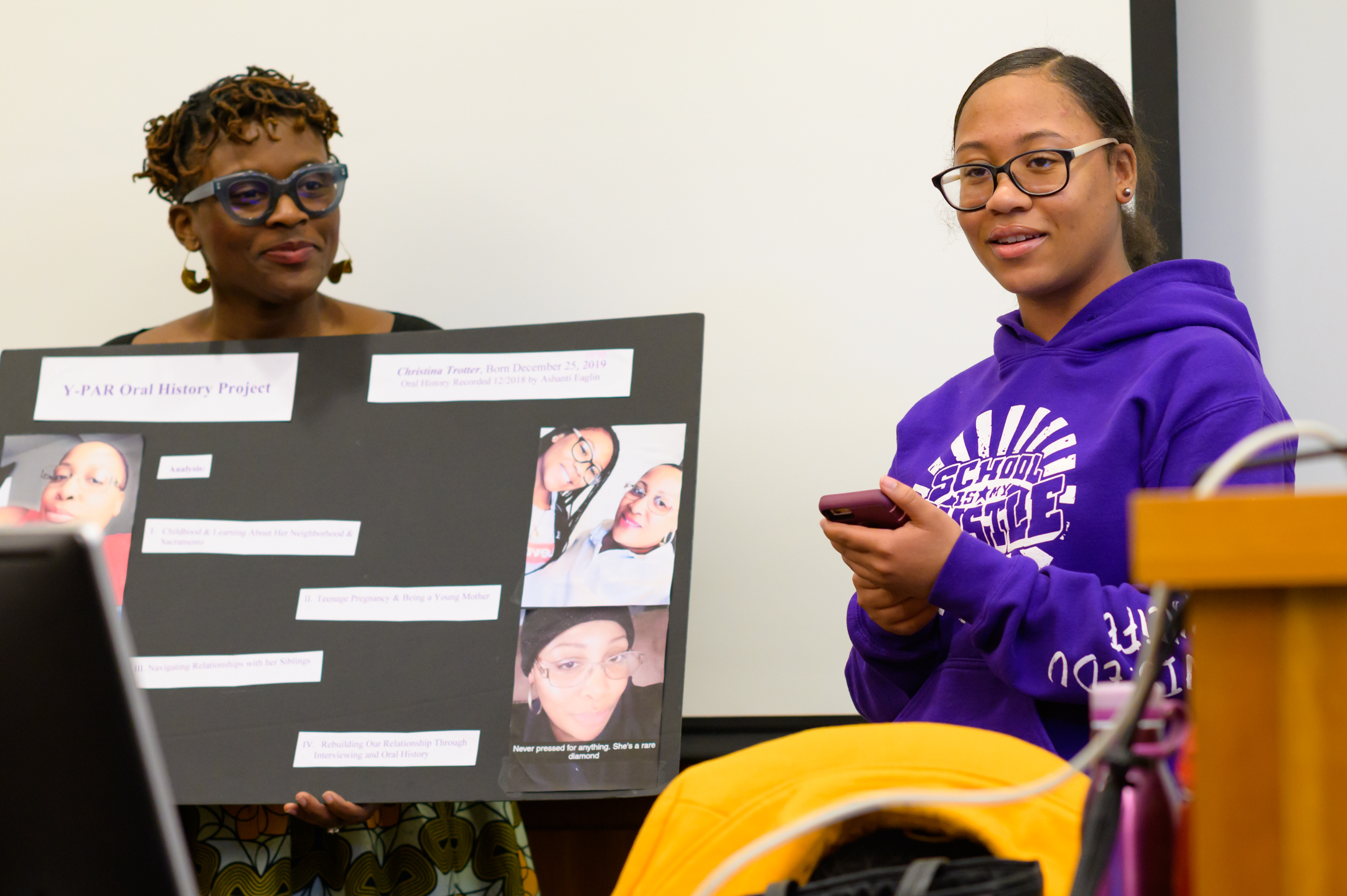 Ashanti E. presents her YPAR project, as Jeanelle Hope holds the poster