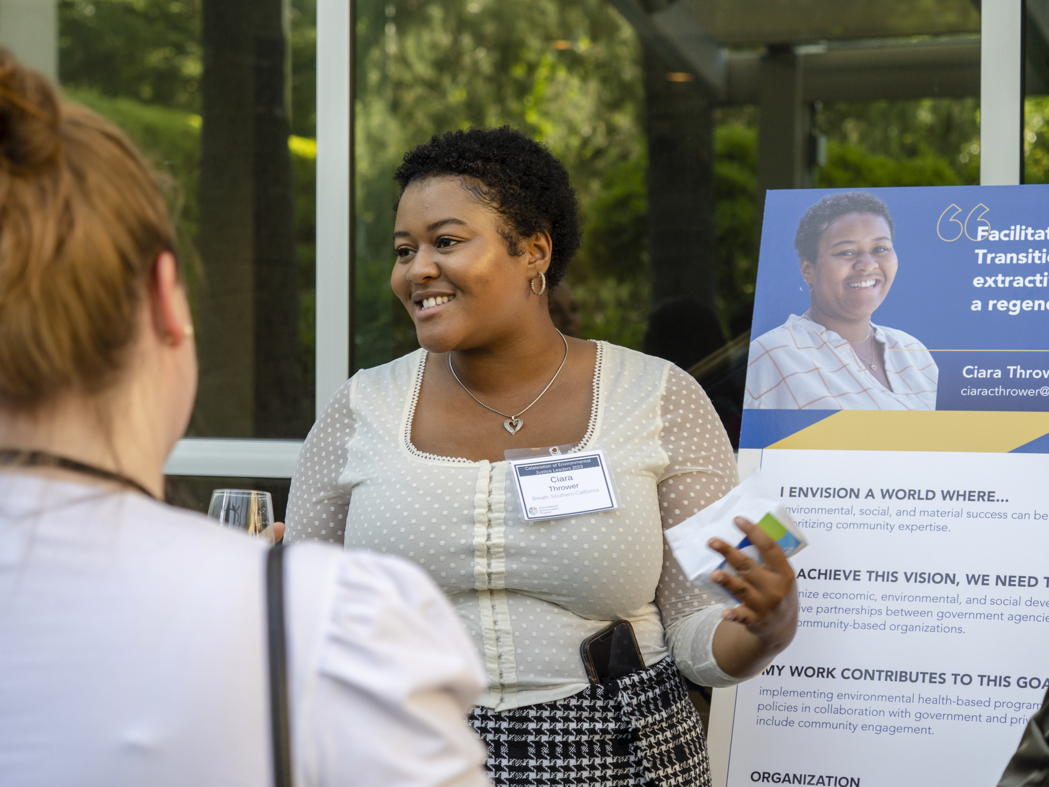 Ciara Thrower speaks in front of poster