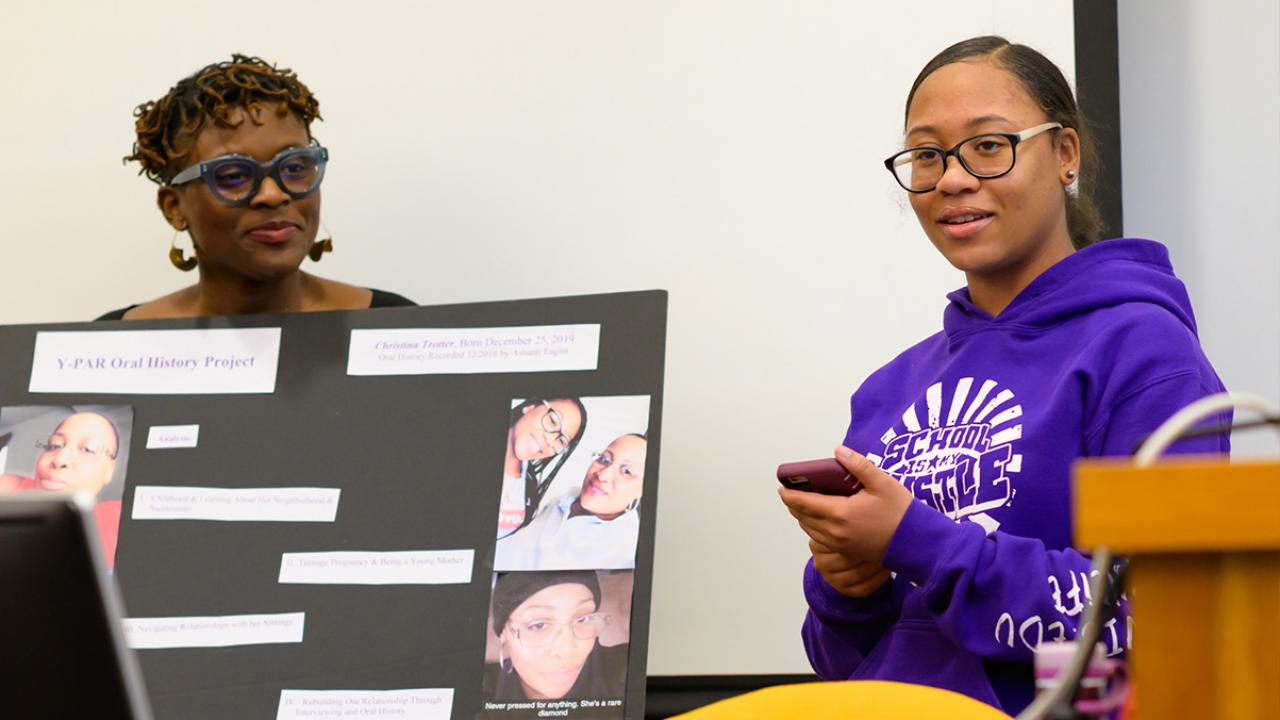 Ashanti E. (right) presents YPAR project while Jeanelle Hope holds poster (right)