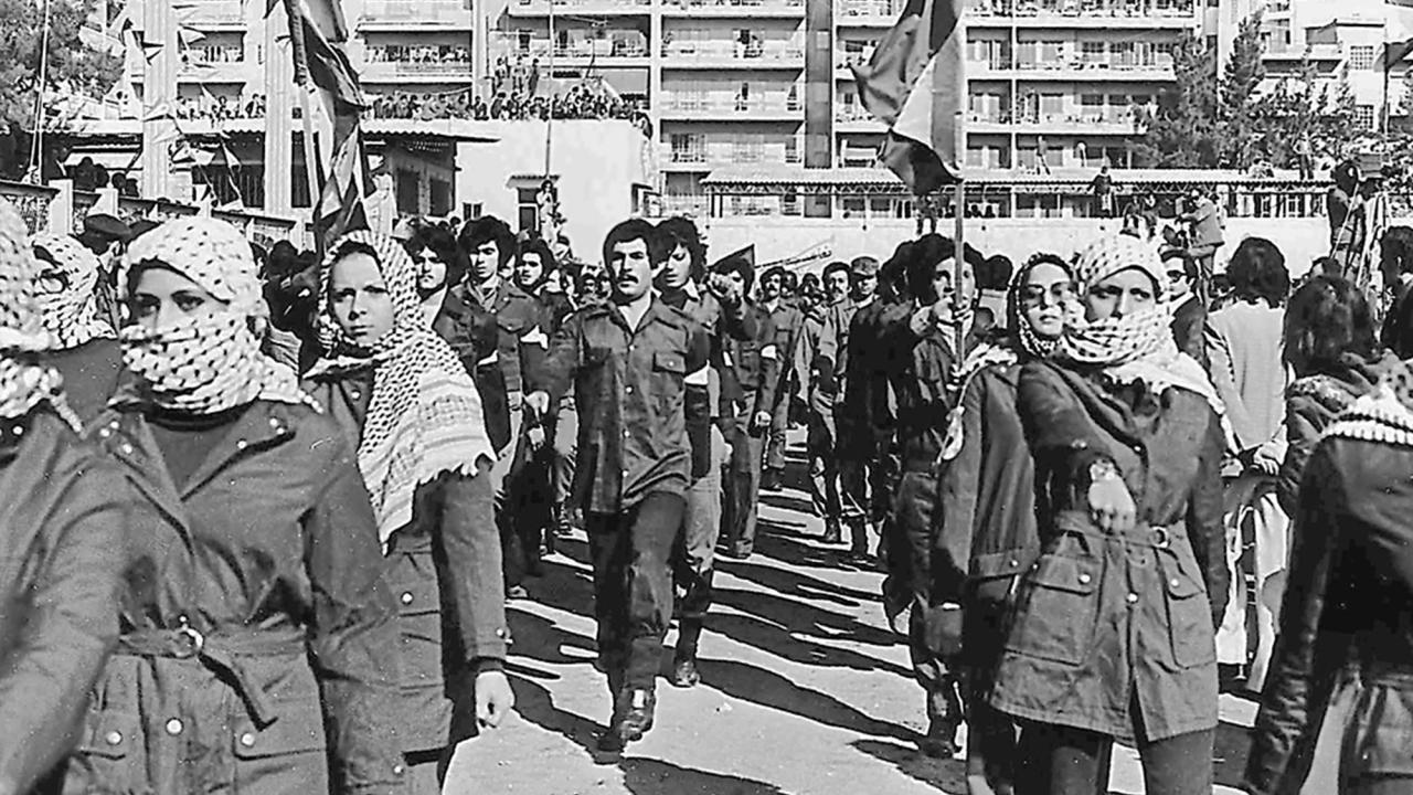 Fedayeen from Fatah in Beirut, 1979. Permission for use from Wikimedia Foundation https://en.wikipedia.org/wiki/PLO_in_Lebanon#/media/File:FatehMilitia.jpg Black and white photo of Fateh Militia marching