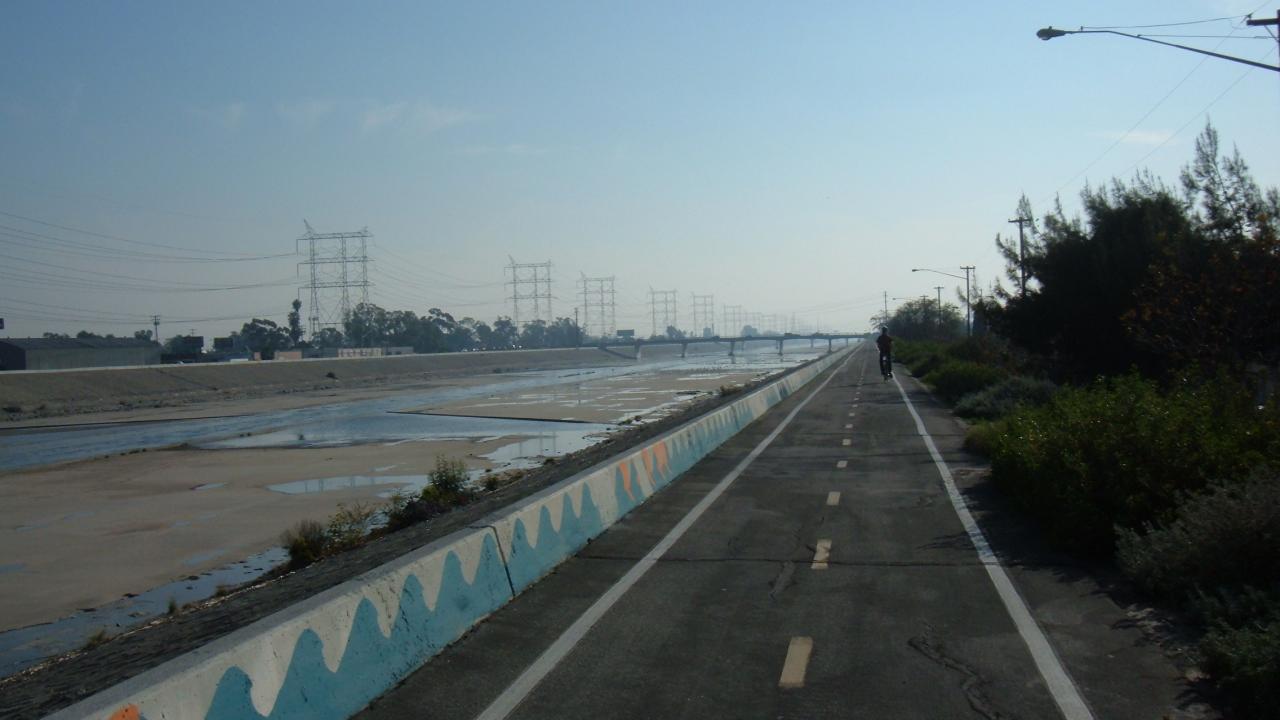 Bike path along LA river with rider in the distance