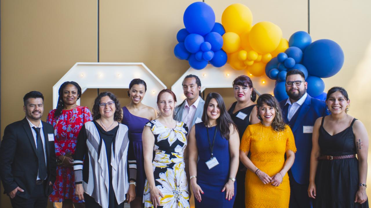 The 2021-22 EJ Fellows and leadership team dressed in formal attire standing smiling.