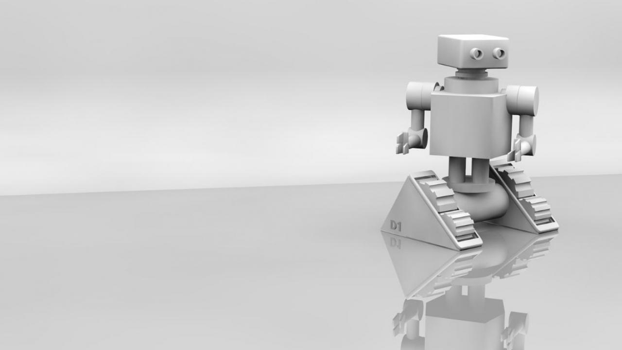 Small robot moves across a blank, glossy table. Black and white photograph.