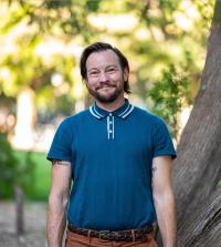 Medium shot of Christoph Lynn Hanssmann in soft shade outdoors
