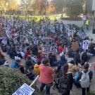 Large group of strikers with signs marching