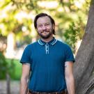Medium shot of Christoph Lynn Hanssmann in soft shade outdoors
