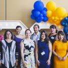 The 2021-22 EJ Fellows and leadership team dressed in formal attire standing smiling.