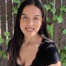 Portrait of Micaella against hanging plants and greenery